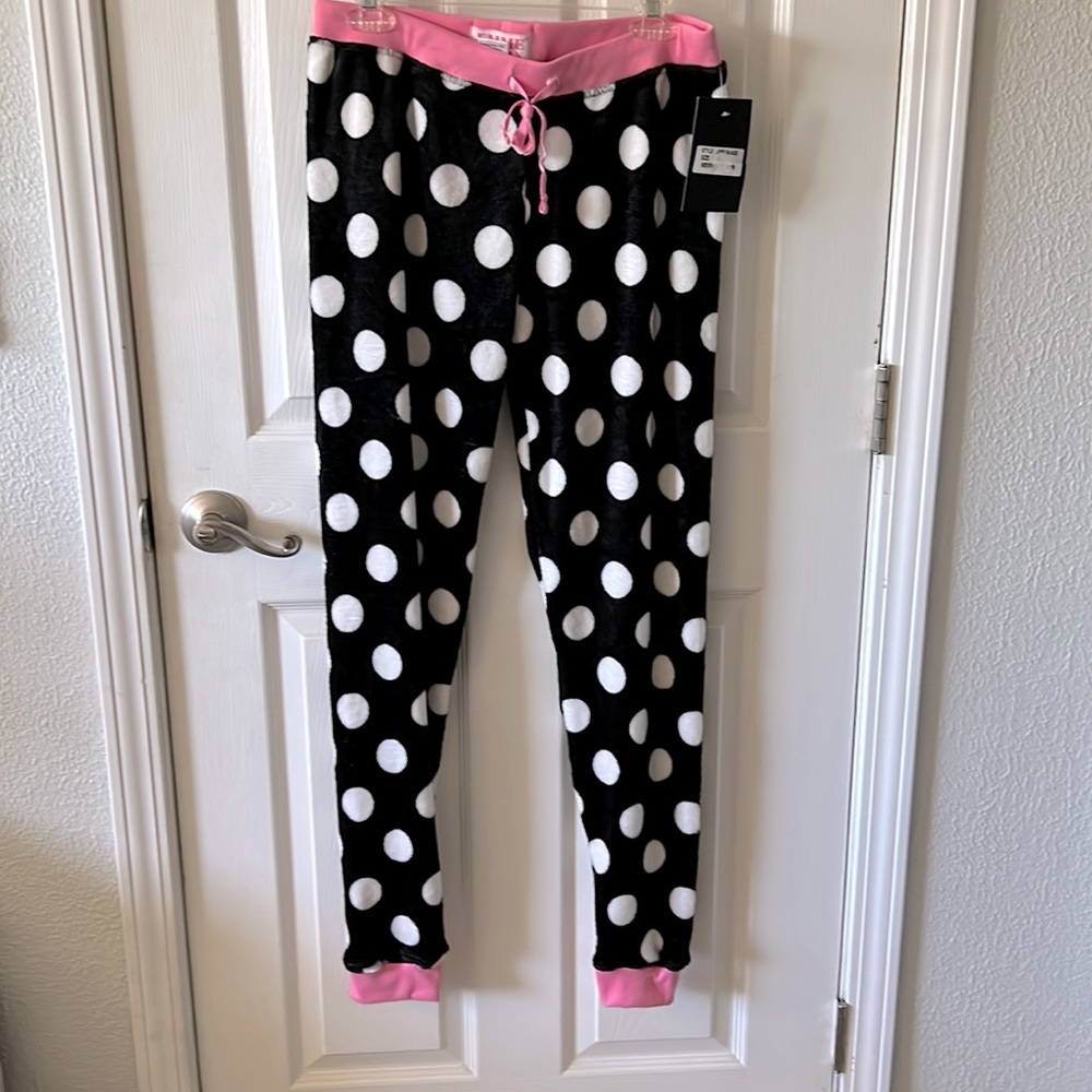 Young woman’s fuzzy black and white polka dot pajama pants